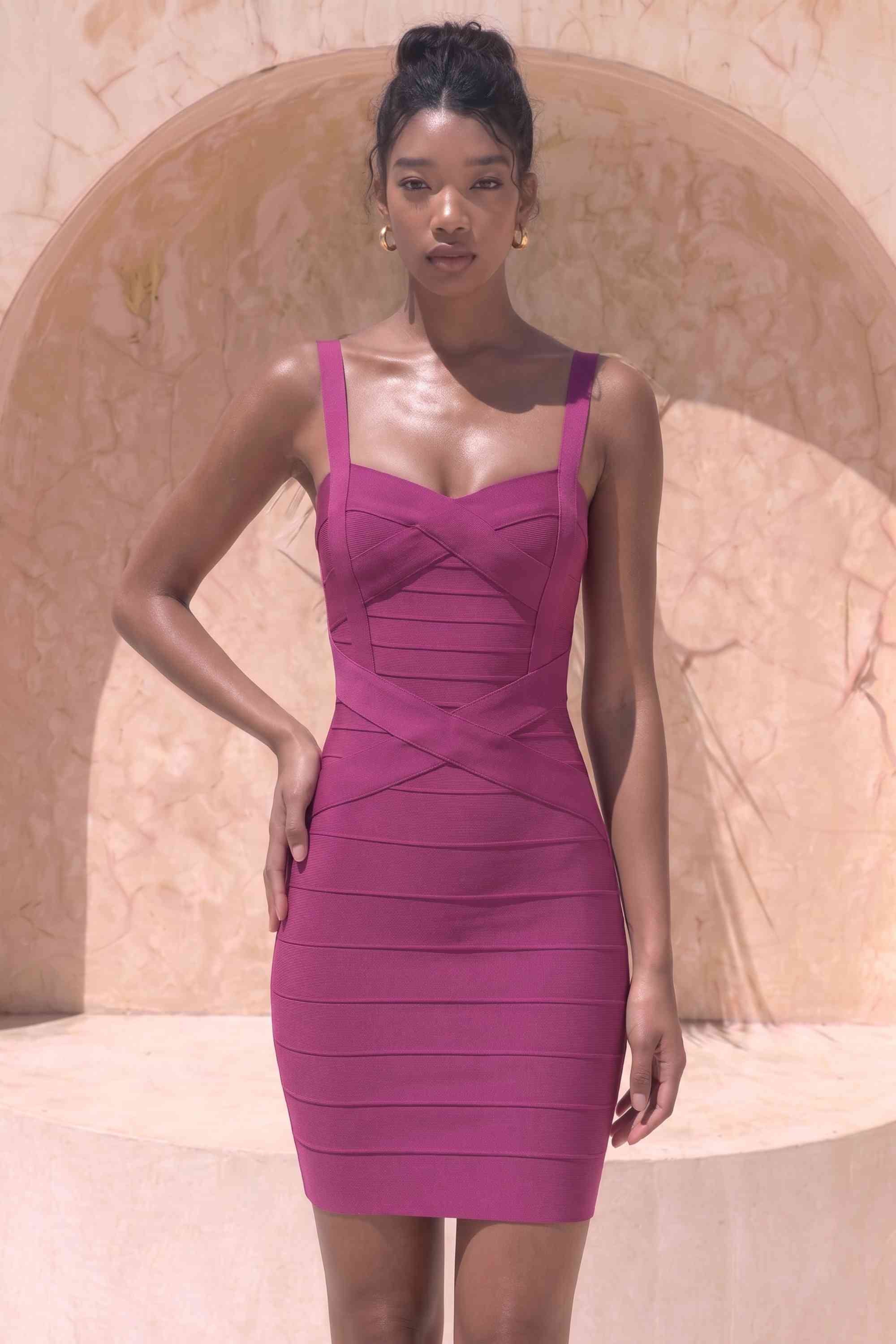 Woman wearing a figure flattering  Heidi Bandage Mini Dress - Magenta Pink Bodycon Collection