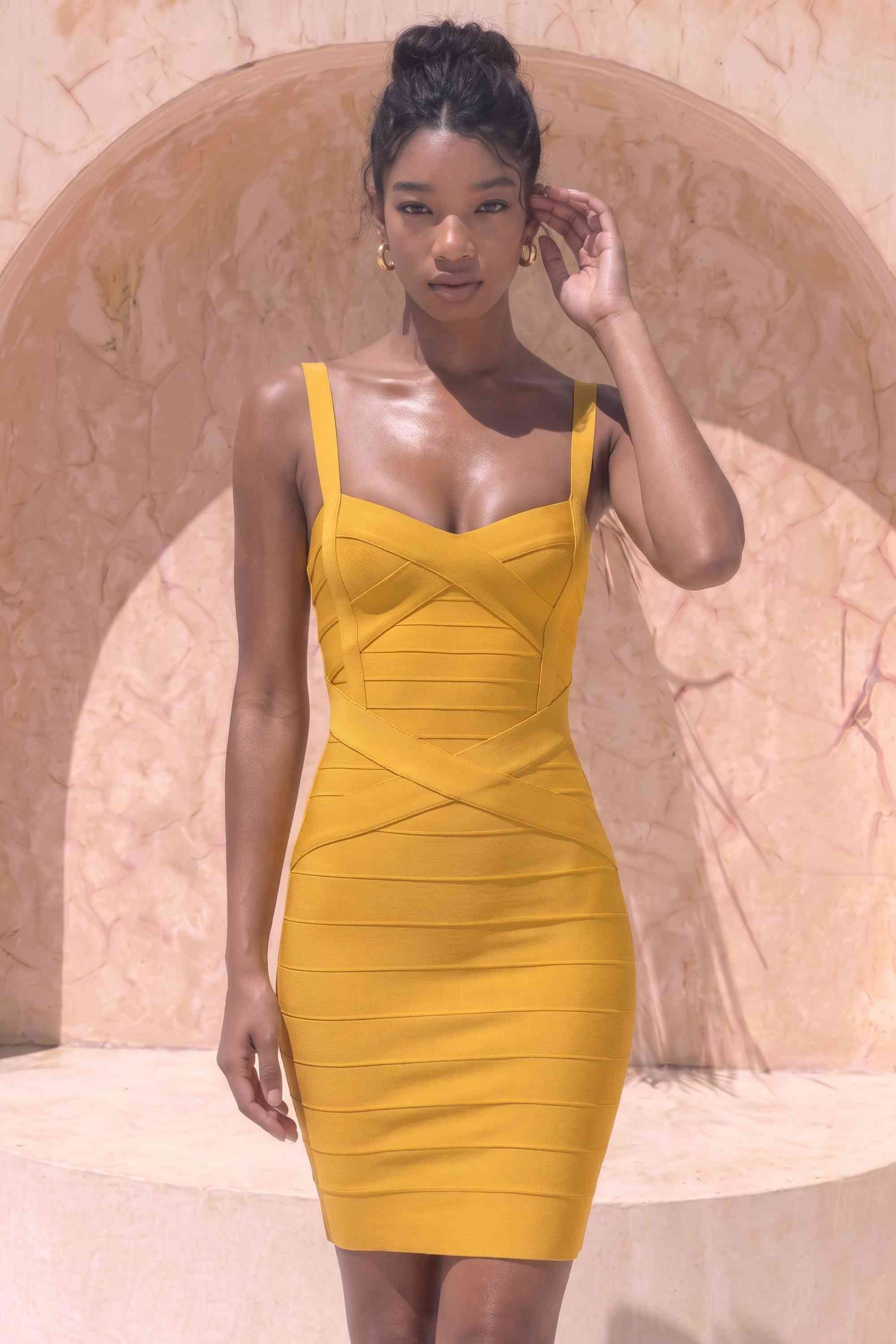Woman wearing a figure flattering  Heidi Bandage Mini Dress - Mustard Yellow Bodycon Collection