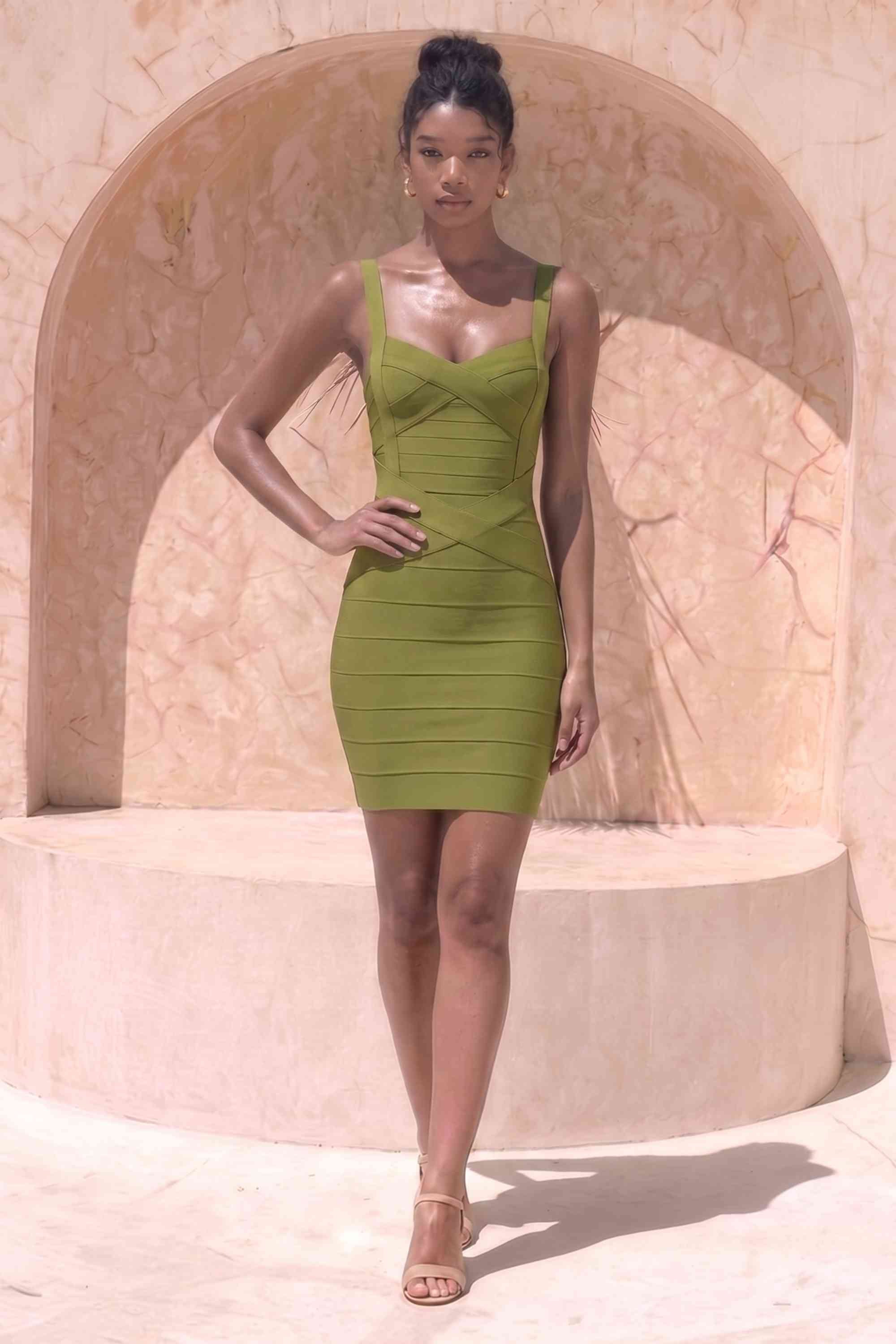 Woman wearing a figure flattering  Heidi Bandage Mini Dress - Olive Green Bodycon Collection