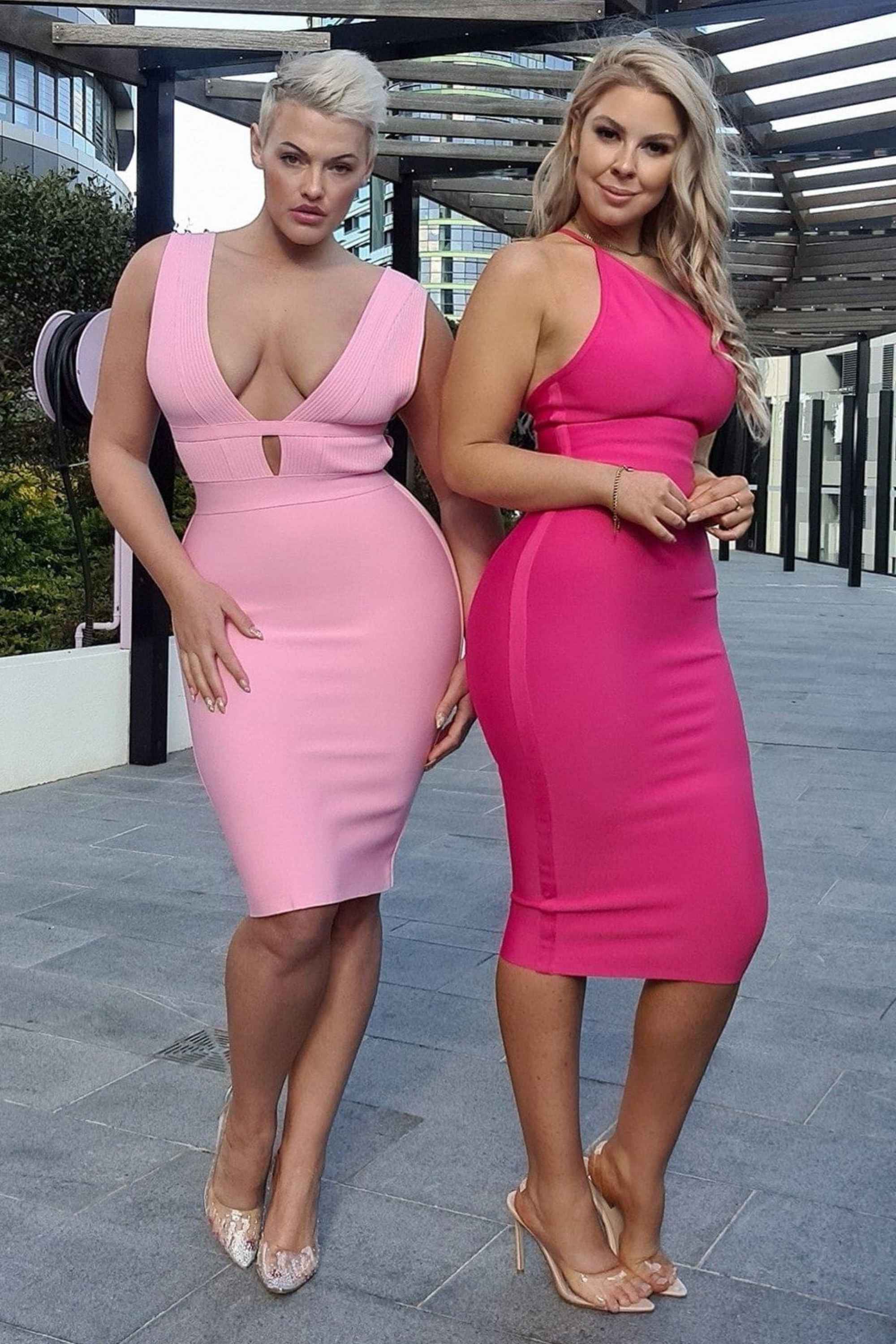 Woman wearing a figure flattering  Joi Bodycon Midi Dress - Hot Pink Bodycon Collection
