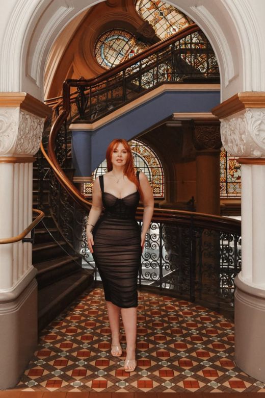 Woman wearing a figure flattering  Marilyn Bodycon Wrap Midi Dress - Classic Black BODYCON COLLECTION