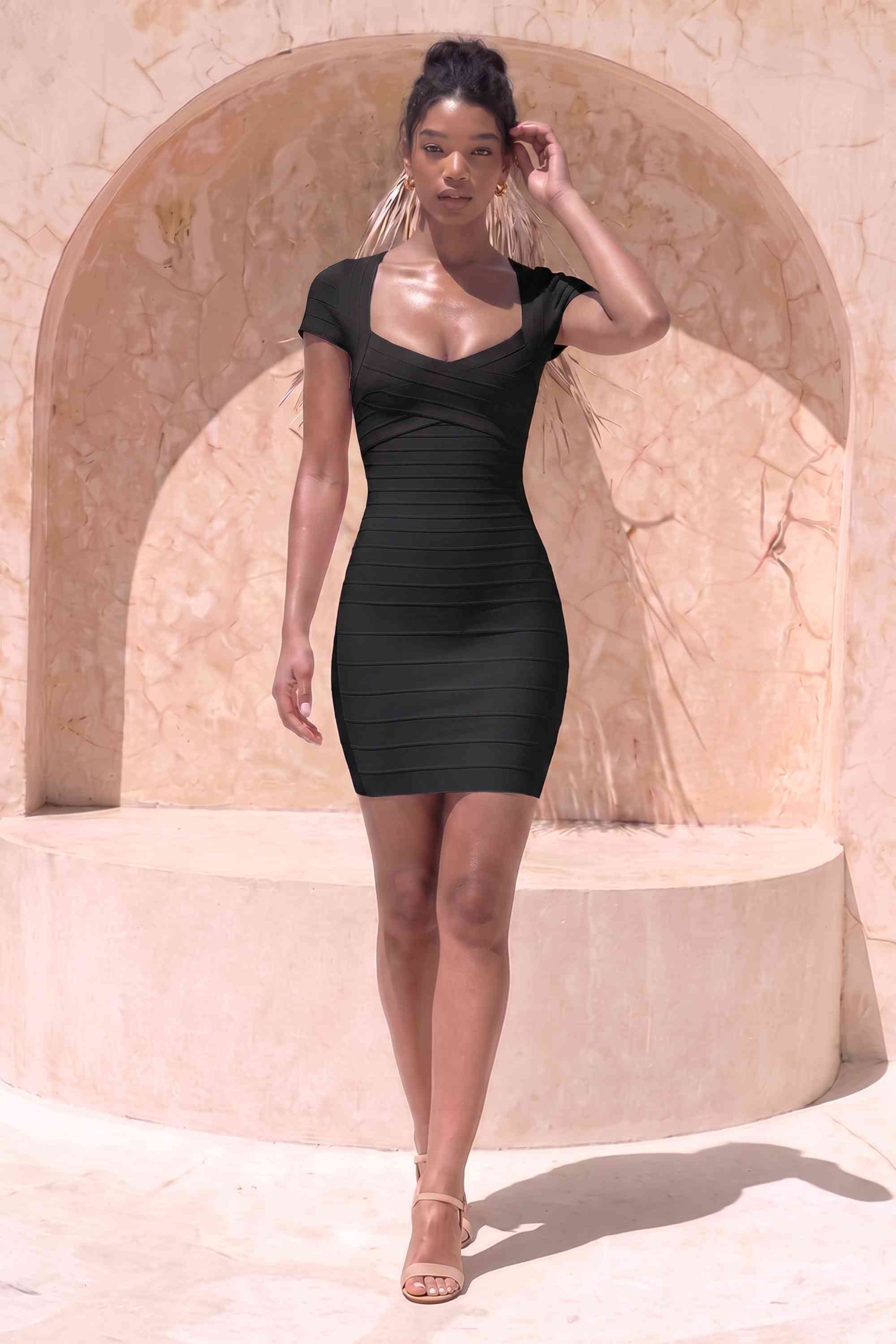 Woman wearing a figure flattering  Miranda Bandage Mini Dress - Classic Black Bodycon Collection
