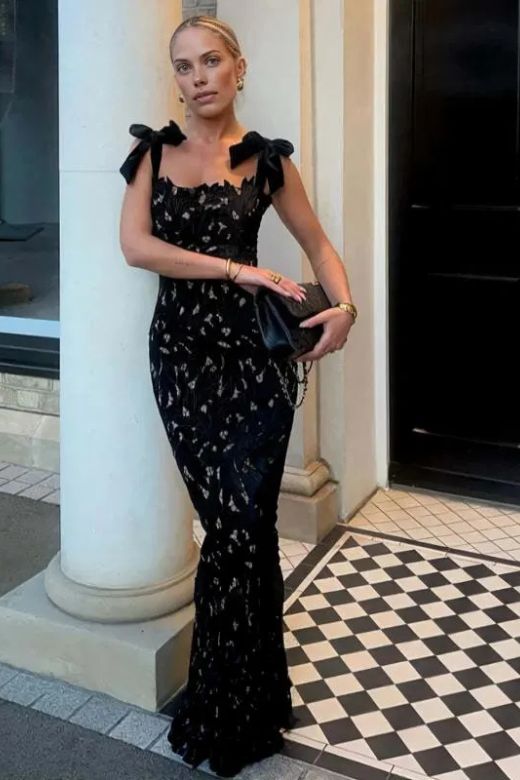 Woman wearing a figure flattering  Odette Bodycon Lace Maxi Dress - Classic Black BODYCON COLLECTION