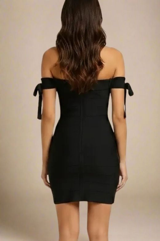 Woman wearing a figure flattering  Penelope Bandage Mini Dress - Classic Black BODYCON COLLECTION