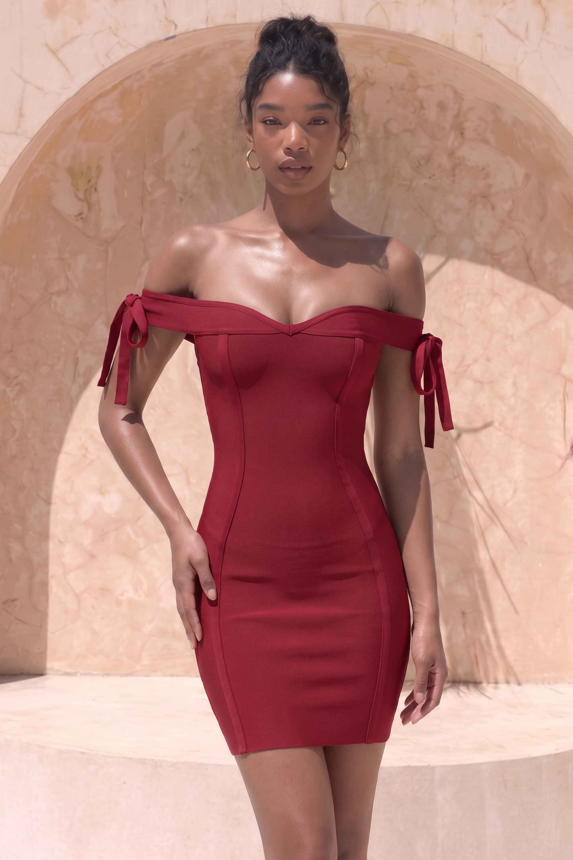 Woman wearing a figure flattering  Penelope Bandage Mini Dress - Red Wine BODYCON COLLECTION