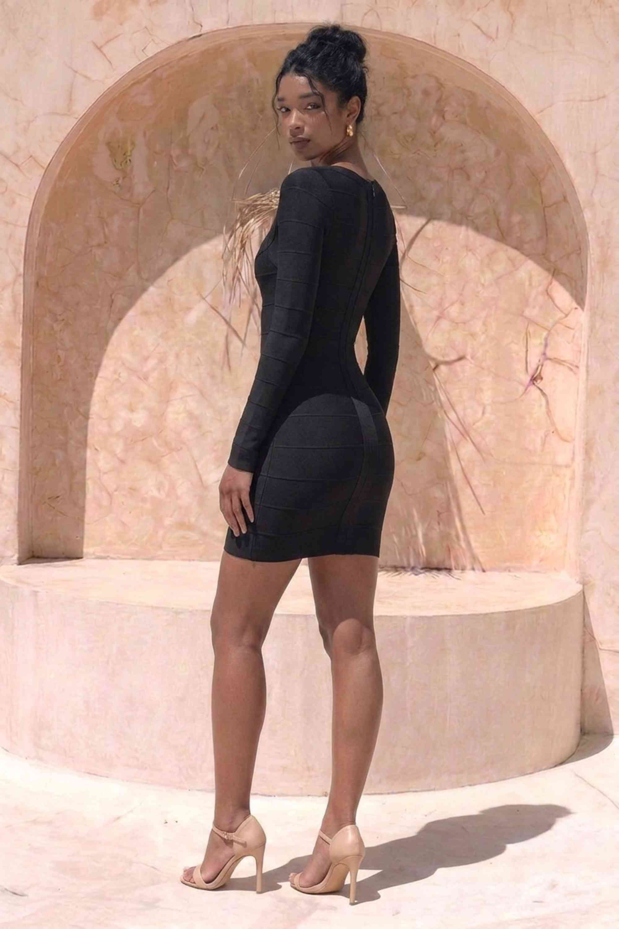 Woman wearing a figure flattering  Valentina Long Sleeve Bandage Mini Dress - Classic Black BODYCON COLLECTION Pty Ltd