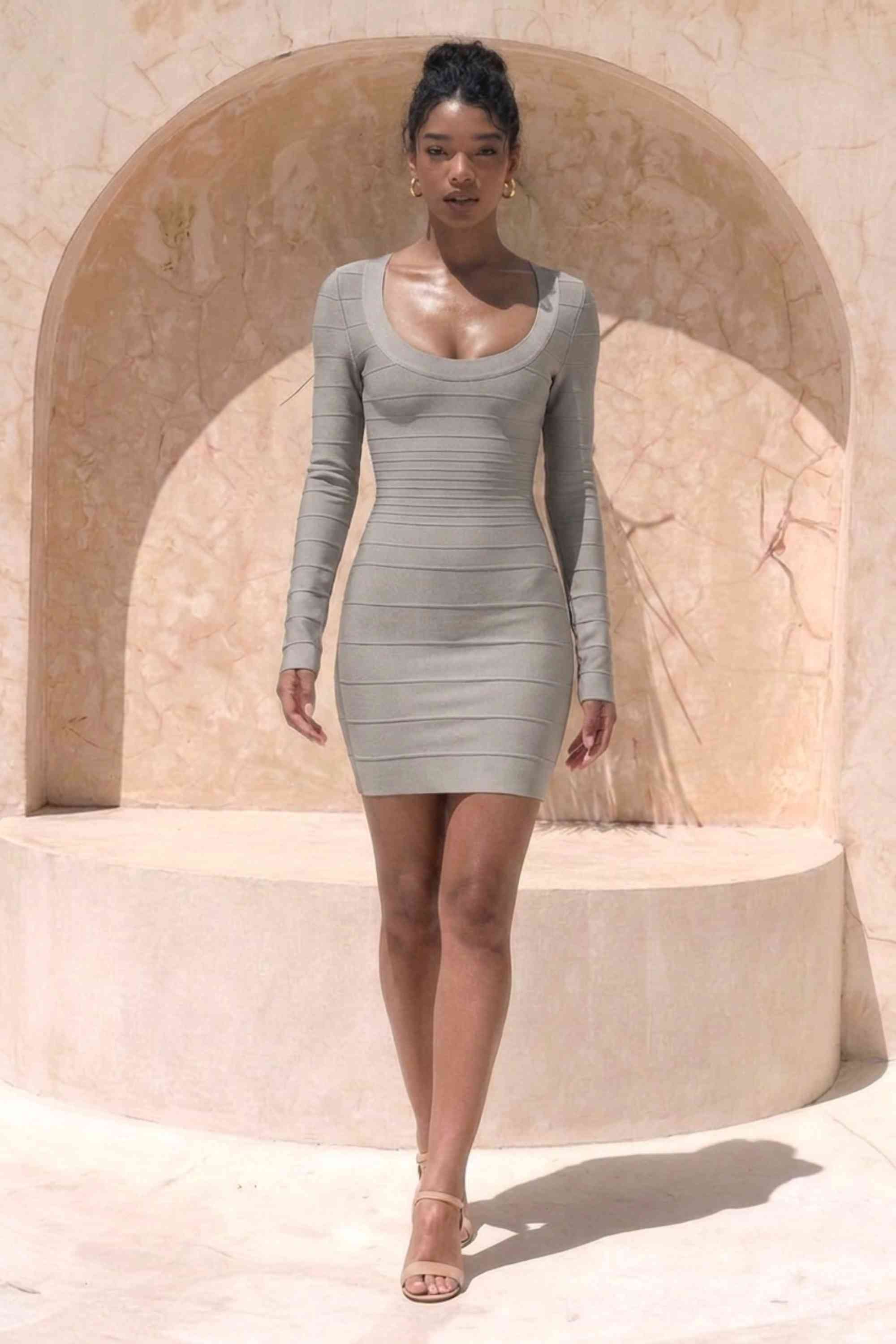 Woman wearing a figure flattering  Valentina Long Sleeve Bandage Mini Dress - Oyster Grey BODYCON COLLECTION Pty Ltd